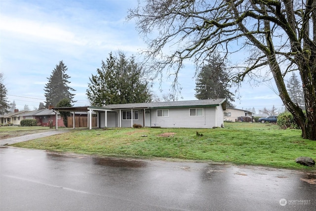 view of front of home with a carport and a front yard