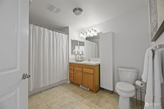 bathroom featuring vanity, walk in shower, and toilet