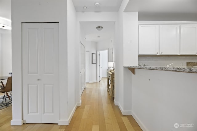 hall with light hardwood / wood-style flooring