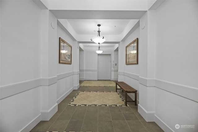 corridor featuring dark tile patterned flooring