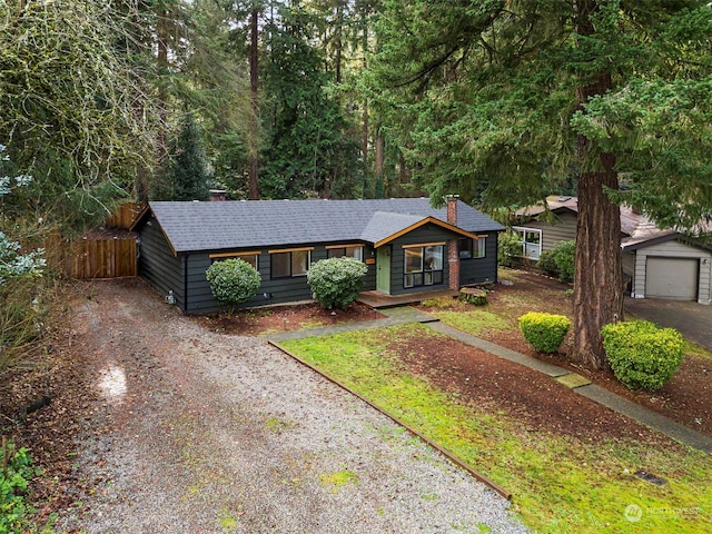 ranch-style house featuring an outbuilding