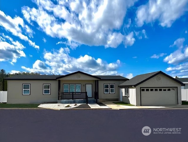 ranch-style home with covered porch and a garage