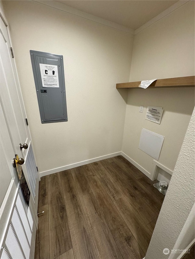 washroom with electric panel, crown molding, and dark wood-type flooring