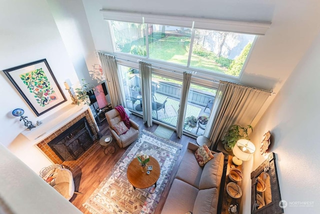 living room featuring a towering ceiling and a tiled fireplace