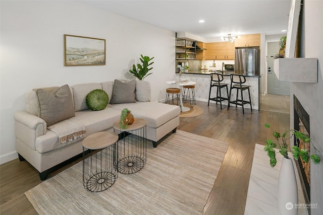 living room featuring hardwood / wood-style flooring and sink