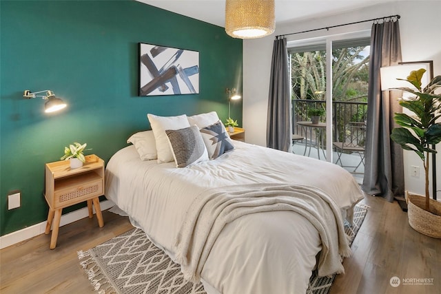 bedroom featuring access to exterior and hardwood / wood-style flooring