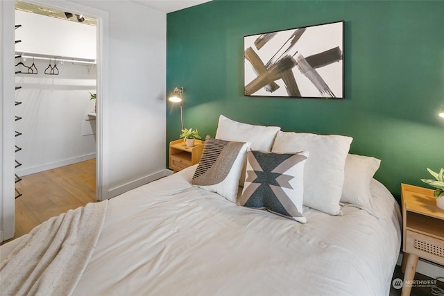 bedroom with a closet and hardwood / wood-style floors