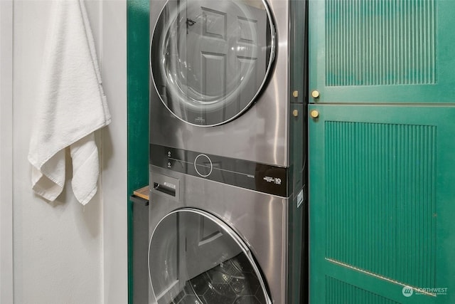 laundry room featuring stacked washer / drying machine