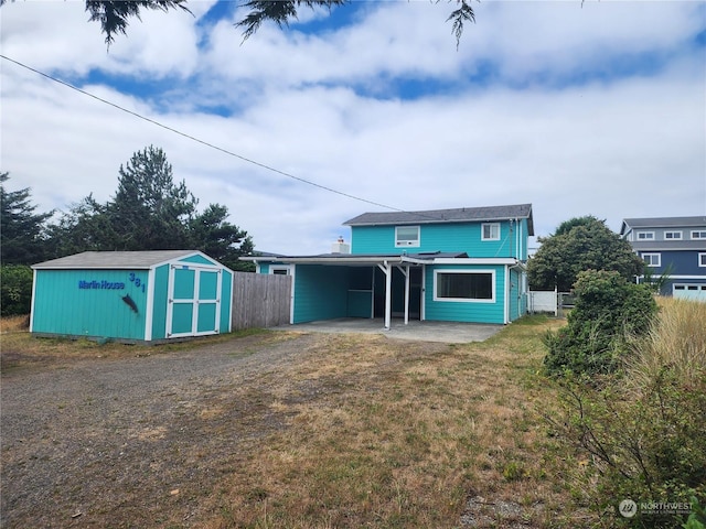 exterior space with a yard, a shed, and a carport