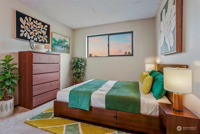 bedroom featuring a textured ceiling and light carpet