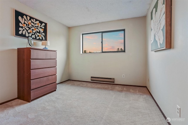 unfurnished bedroom featuring light colored carpet and a textured ceiling