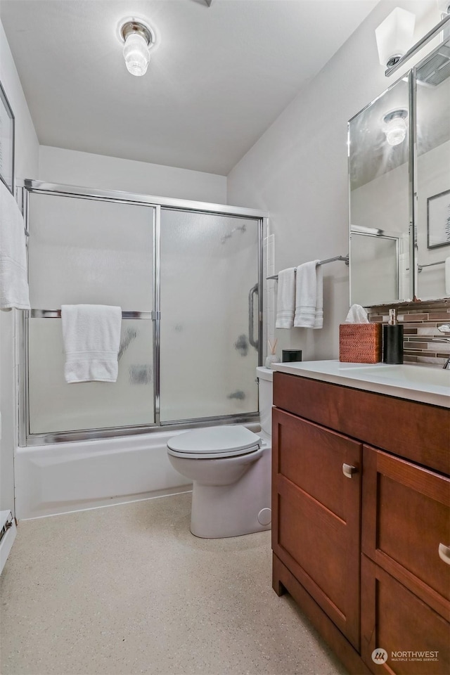 full bathroom with vanity, toilet, and bath / shower combo with glass door