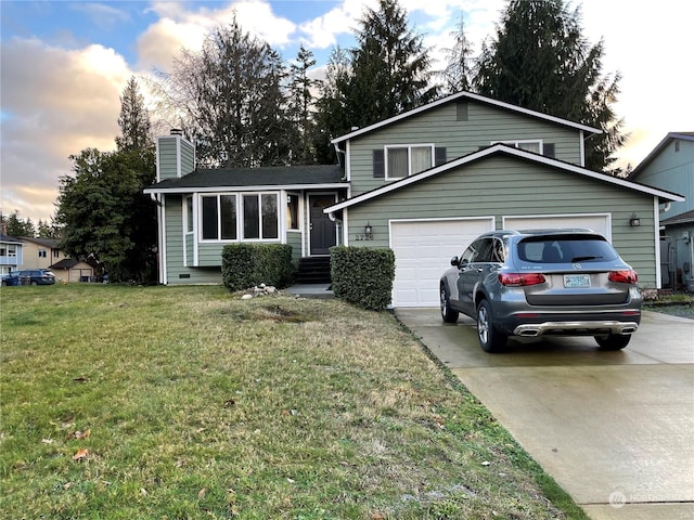 tri-level home featuring a lawn and a garage