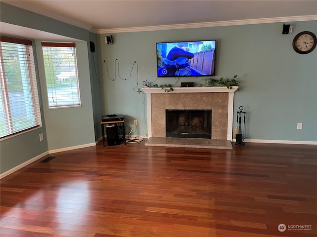 unfurnished living room with a fireplace, wood-type flooring, and crown molding