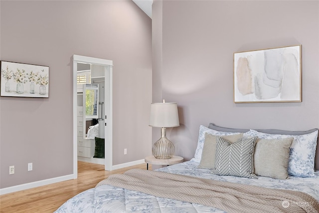 bedroom featuring lofted ceiling and hardwood / wood-style floors