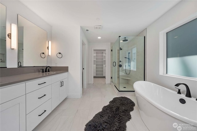 bathroom featuring separate shower and tub and vanity