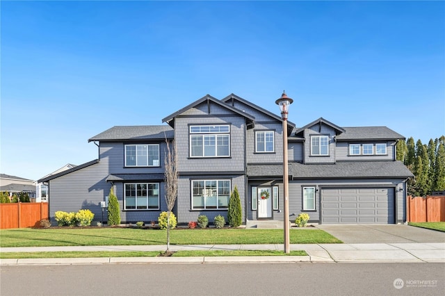 view of front facade with a garage and a front lawn