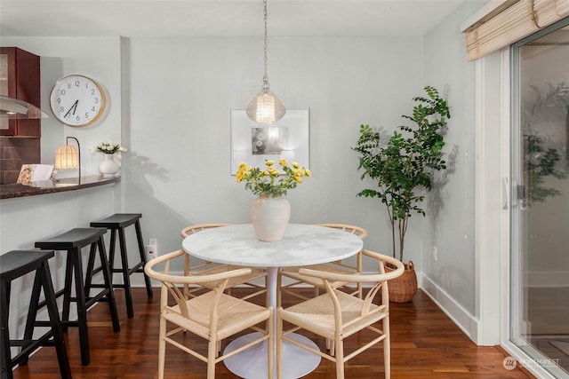 dining area with dark hardwood / wood-style floors