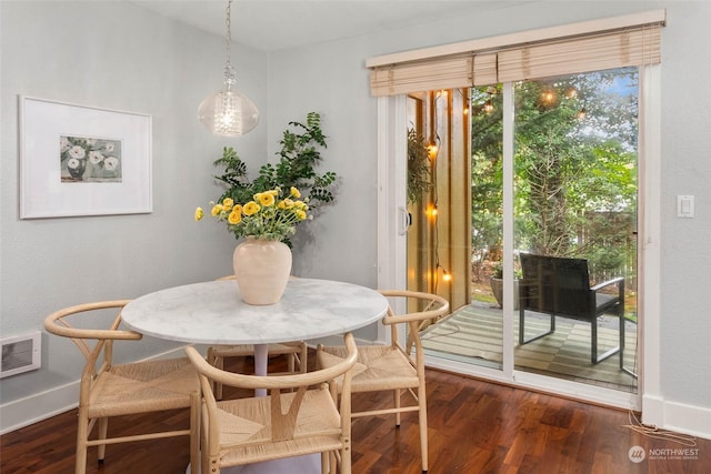 dining space with dark hardwood / wood-style floors and breakfast area