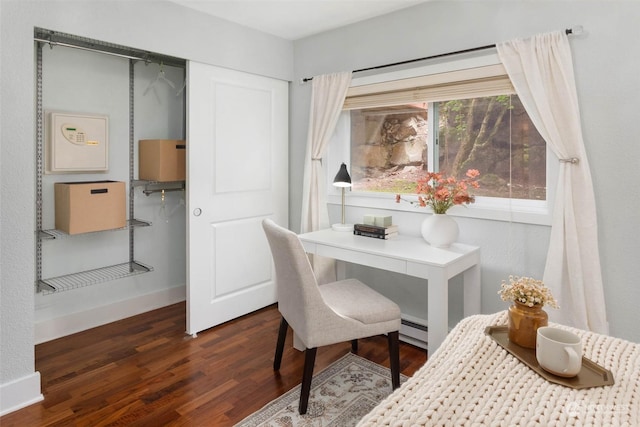 office area with a baseboard radiator and dark hardwood / wood-style floors