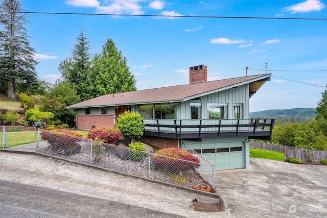 view of front facade featuring a garage and a mountain view