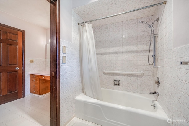 bathroom featuring tile walls, shower / tub combo with curtain, and tile patterned floors