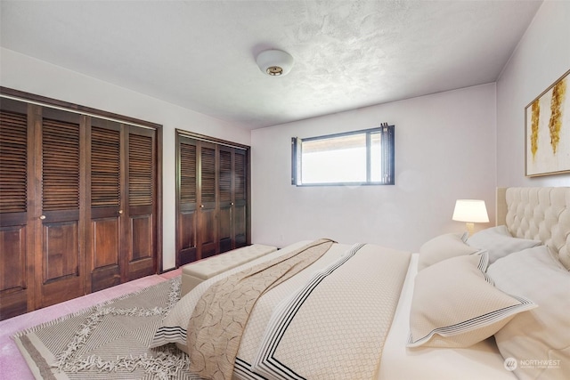 bedroom featuring multiple closets