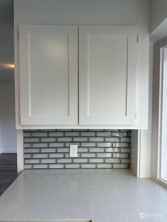 interior details with light stone countertops and white cabinets