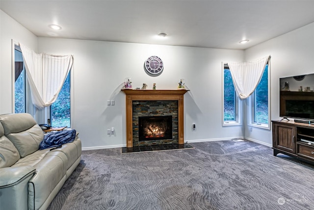 living room featuring carpet flooring and a fireplace