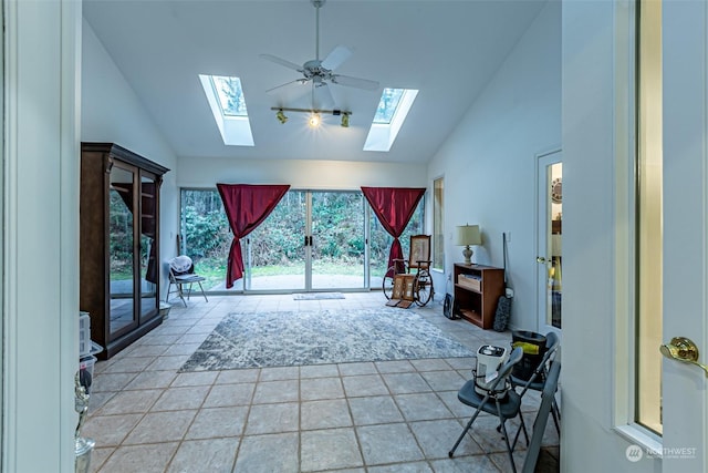 interior space with vaulted ceiling with skylight and ceiling fan