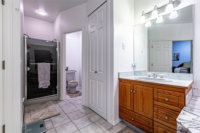 bathroom featuring tile patterned floors, vanity, and toilet