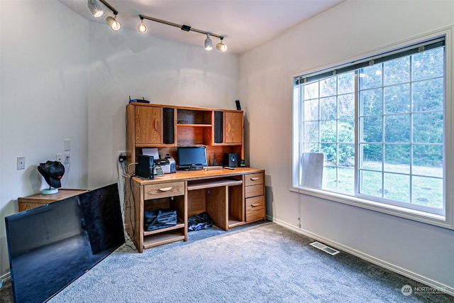 carpeted home office with track lighting