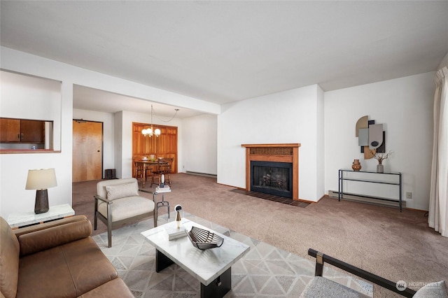 carpeted living room featuring a baseboard heating unit and an inviting chandelier