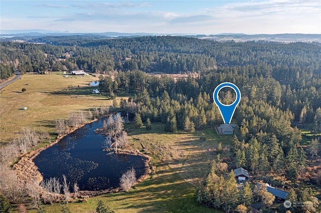 drone / aerial view featuring a wooded view