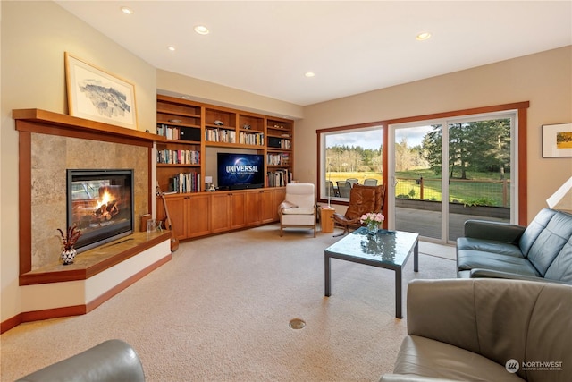 living area with light carpet, baseboards, a tiled fireplace, and recessed lighting