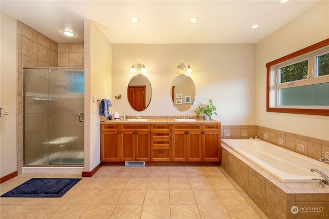 full bathroom featuring a garden tub, double vanity, a stall shower, and a sink