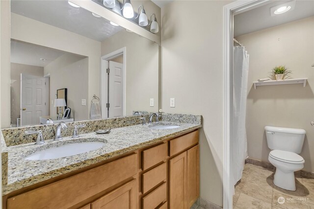 bathroom featuring toilet and vanity