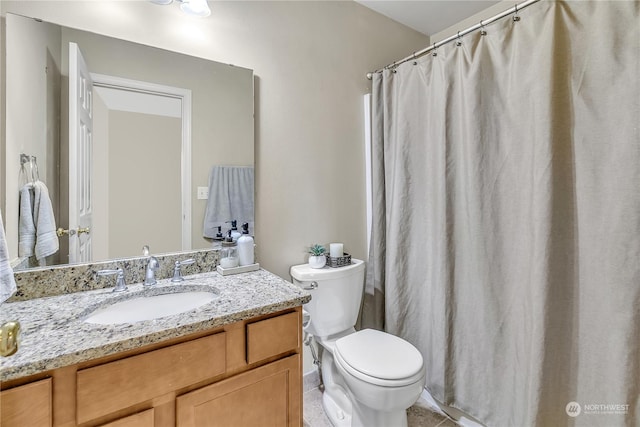 bathroom with toilet, tile patterned floors, and vanity