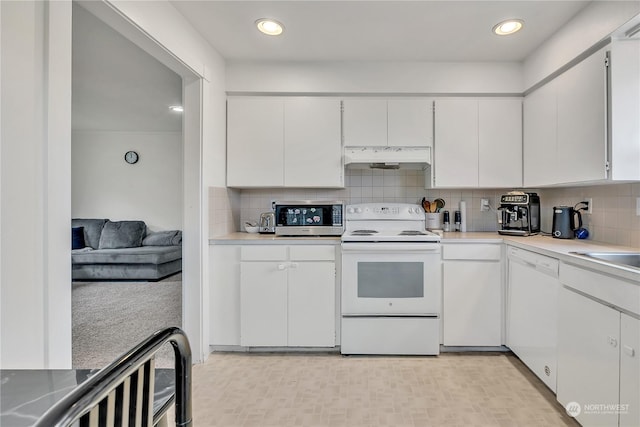 kitchen with tasteful backsplash, white appliances, and white cabinetry