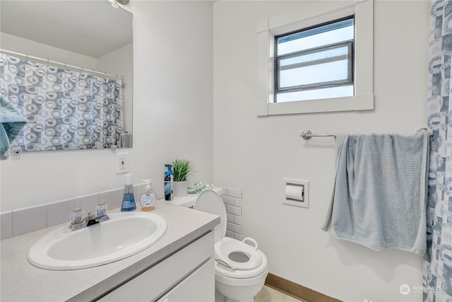 bathroom with toilet and vanity