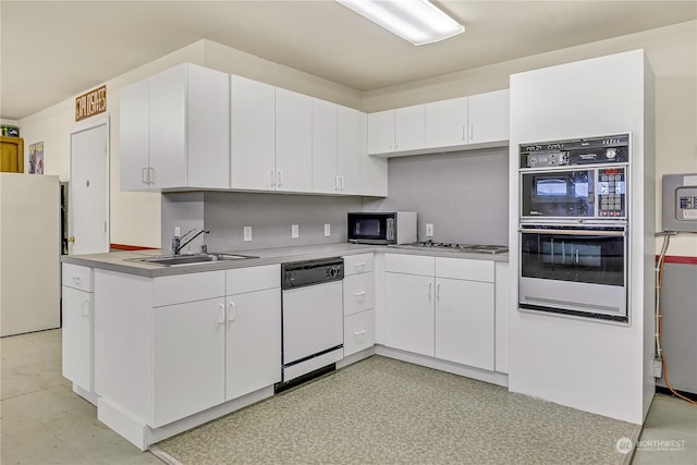 kitchen featuring tasteful backsplash, white cabinets, sink, and white appliances