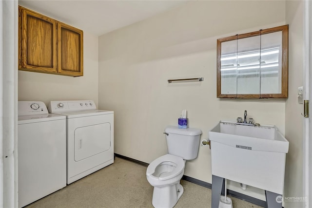 clothes washing area featuring sink and washer and clothes dryer