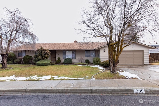 single story home featuring a garage and a front lawn