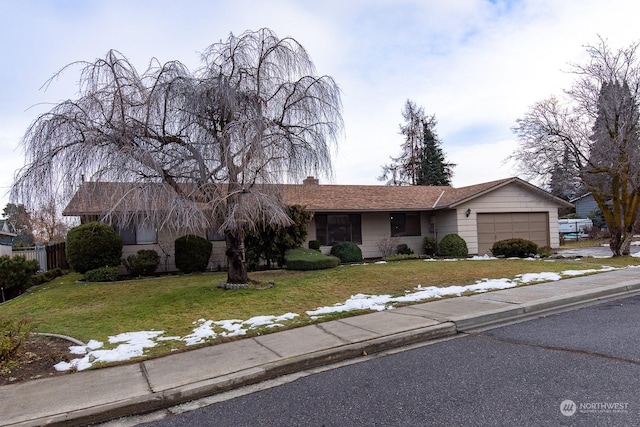 single story home featuring a front lawn and a garage