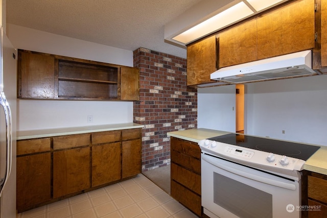 kitchen featuring a textured ceiling, white appliances, and ventilation hood