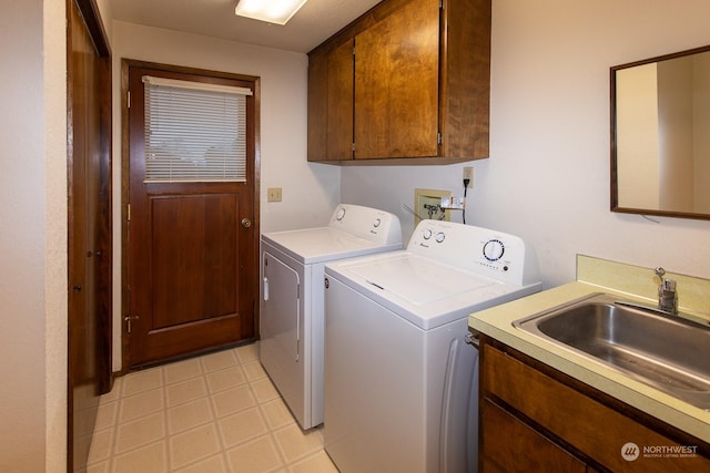 clothes washing area featuring cabinets, independent washer and dryer, and sink