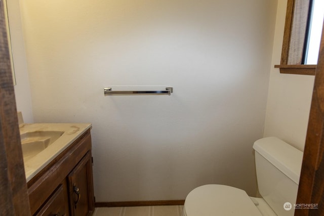 bathroom featuring tile patterned floors, vanity, and toilet