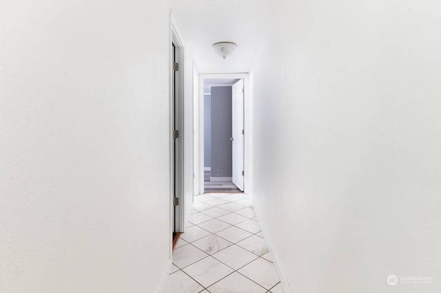 hall featuring light tile patterned flooring