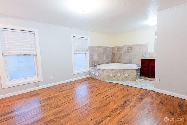 unfurnished bedroom featuring light wood-type flooring and a textured ceiling