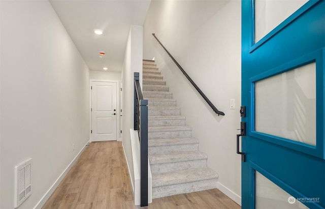 stairs with hardwood / wood-style floors